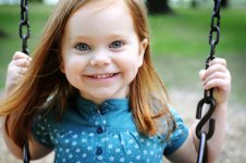 happy_little_girl_swinging_on_a_swing_380x253.jpg